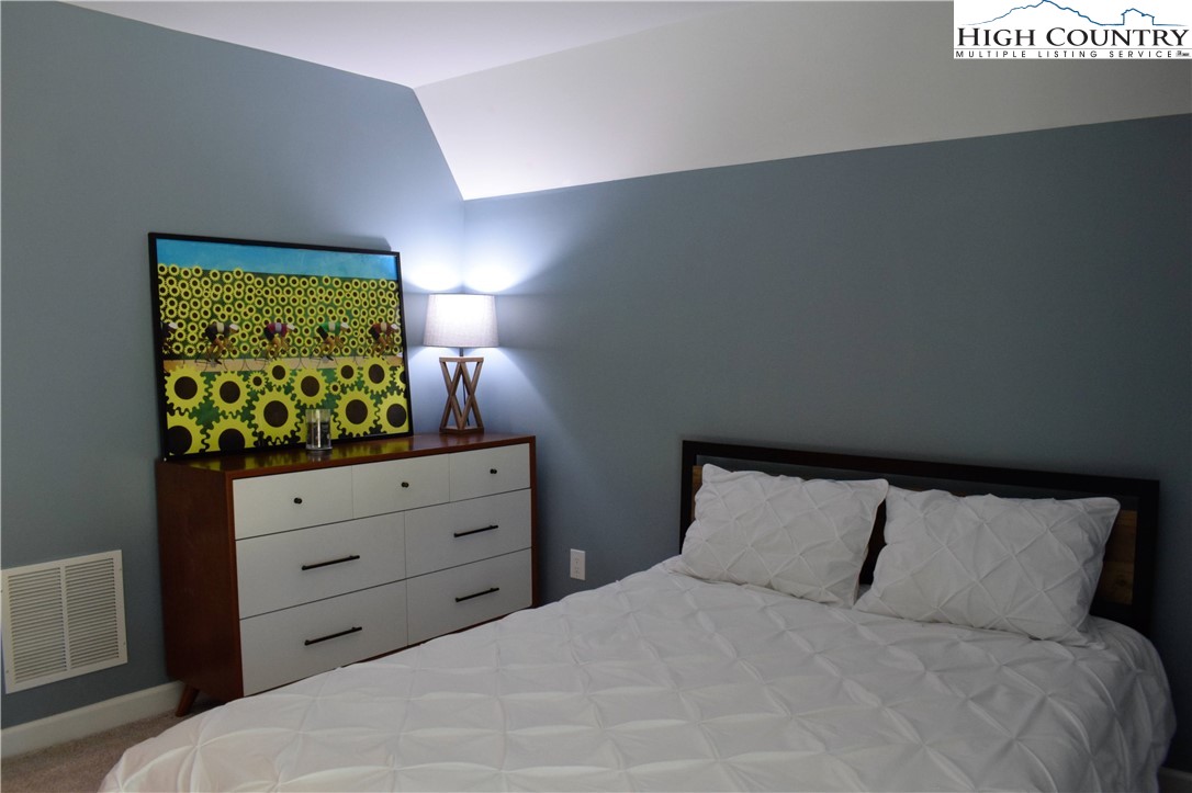 146 Trillium Ridge Boone, NC 28607 - Photo 23 of 41 a bed room with a bed and a night stand