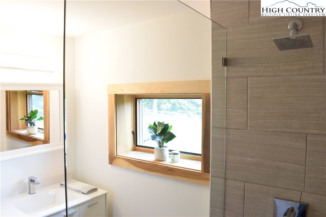 146 Trillium Ridge Boone, NC 28607 - Photo 24 of 41 a bathroom with a sink a mirror and a window