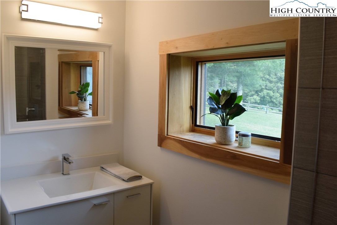146 Trillium Ridge Boone, NC 28607 - Photo 25 of 41 a bathroom with a window sink and mirror