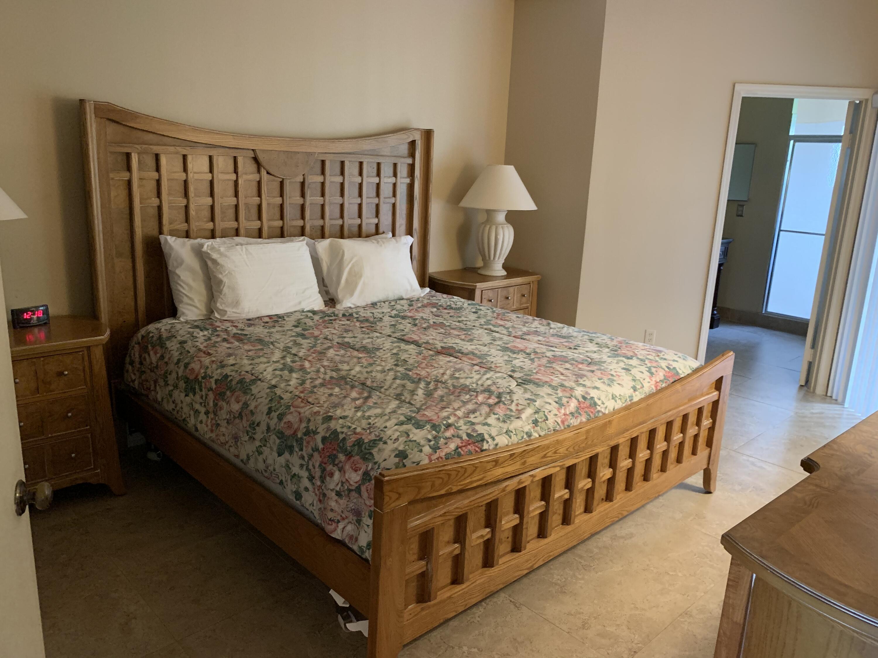 6674 Montego Bay Boulevard, Unit E Boca Raton, FL 33433 - Photo 12 of 18 a bed sitting in a bedroom next to a window with dresser