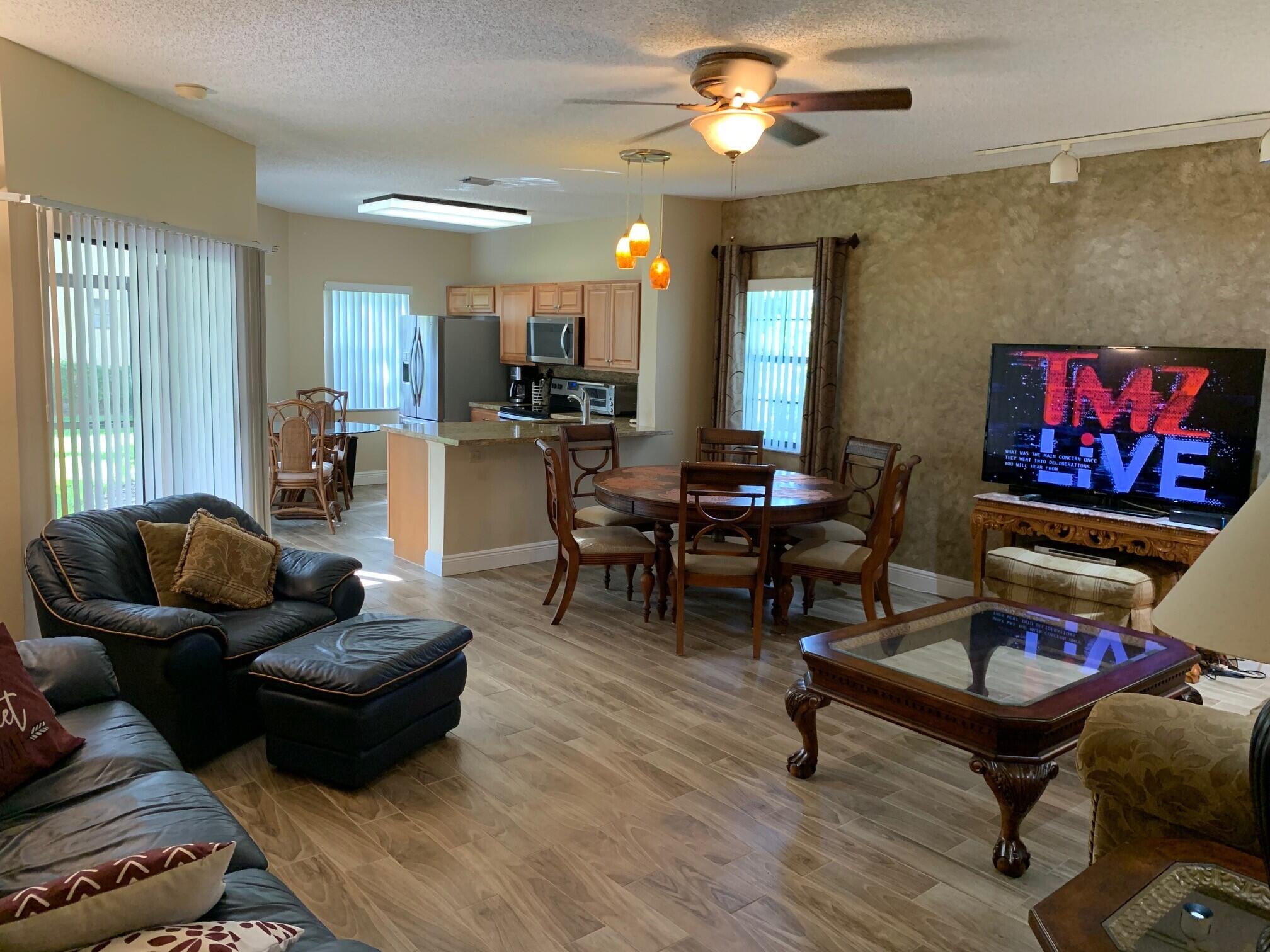 6674 Montego Bay Boulevard, Unit E Boca Raton, FL 33433 - Photo 14 of 18 a living room with furniture and a flat screen tv