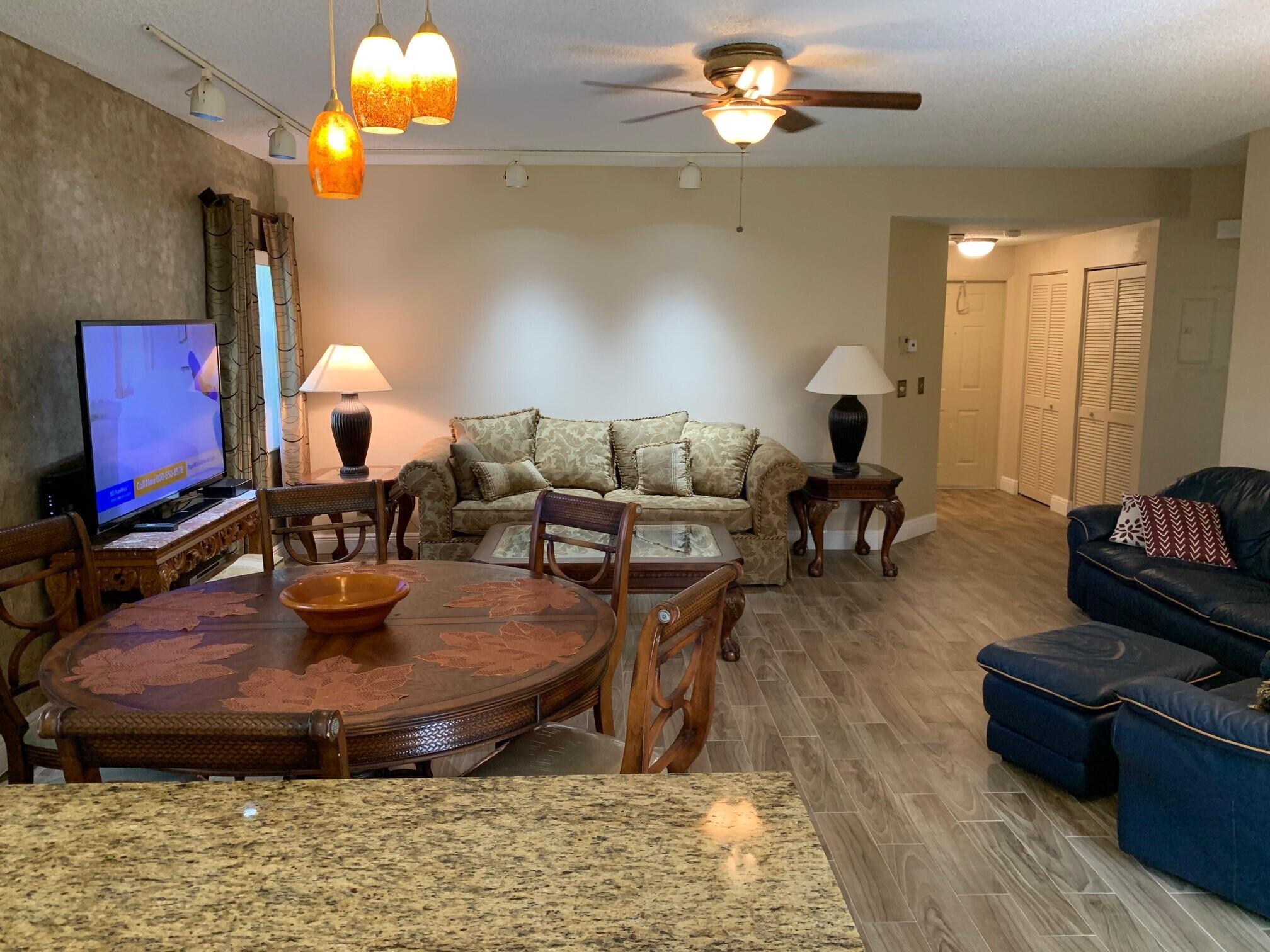 6674 Montego Bay Boulevard, Unit E Boca Raton, FL 33433 - Photo 15 of 18 a living room with furniture and a chandelier