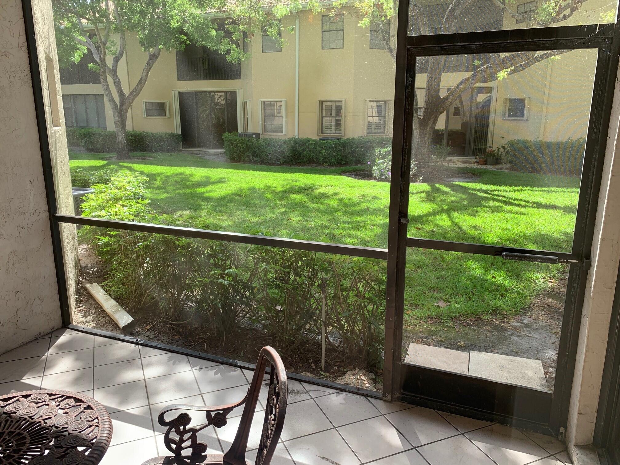 6674 Montego Bay Boulevard, Unit E Boca Raton, FL 33433 - Photo 16 of 18 a view of a porch and garden