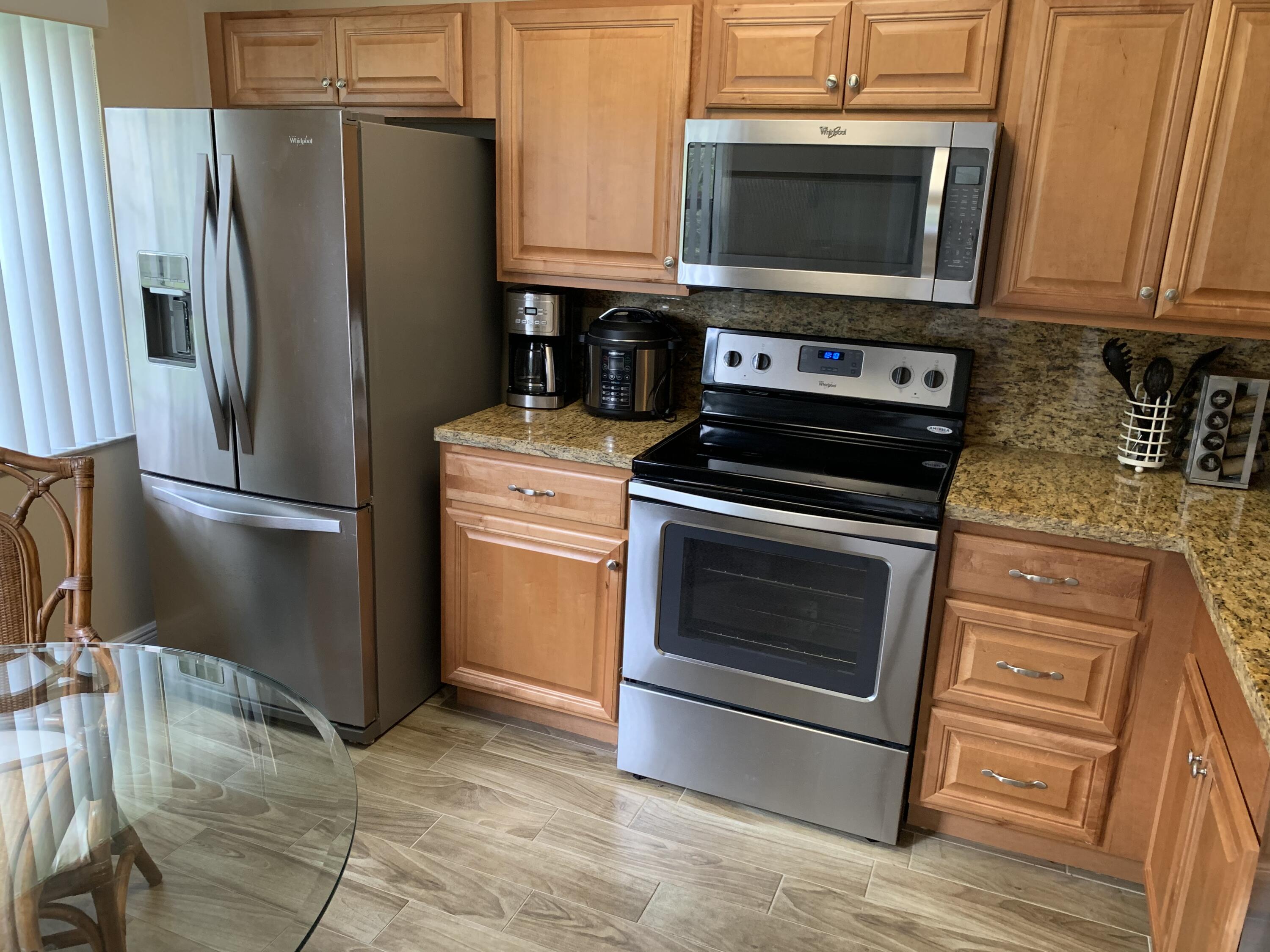 6674 Montego Bay Boulevard, Unit E Boca Raton, FL 33433 - Photo 2 of 18 a kitchen with a stove microwave and refrigerator