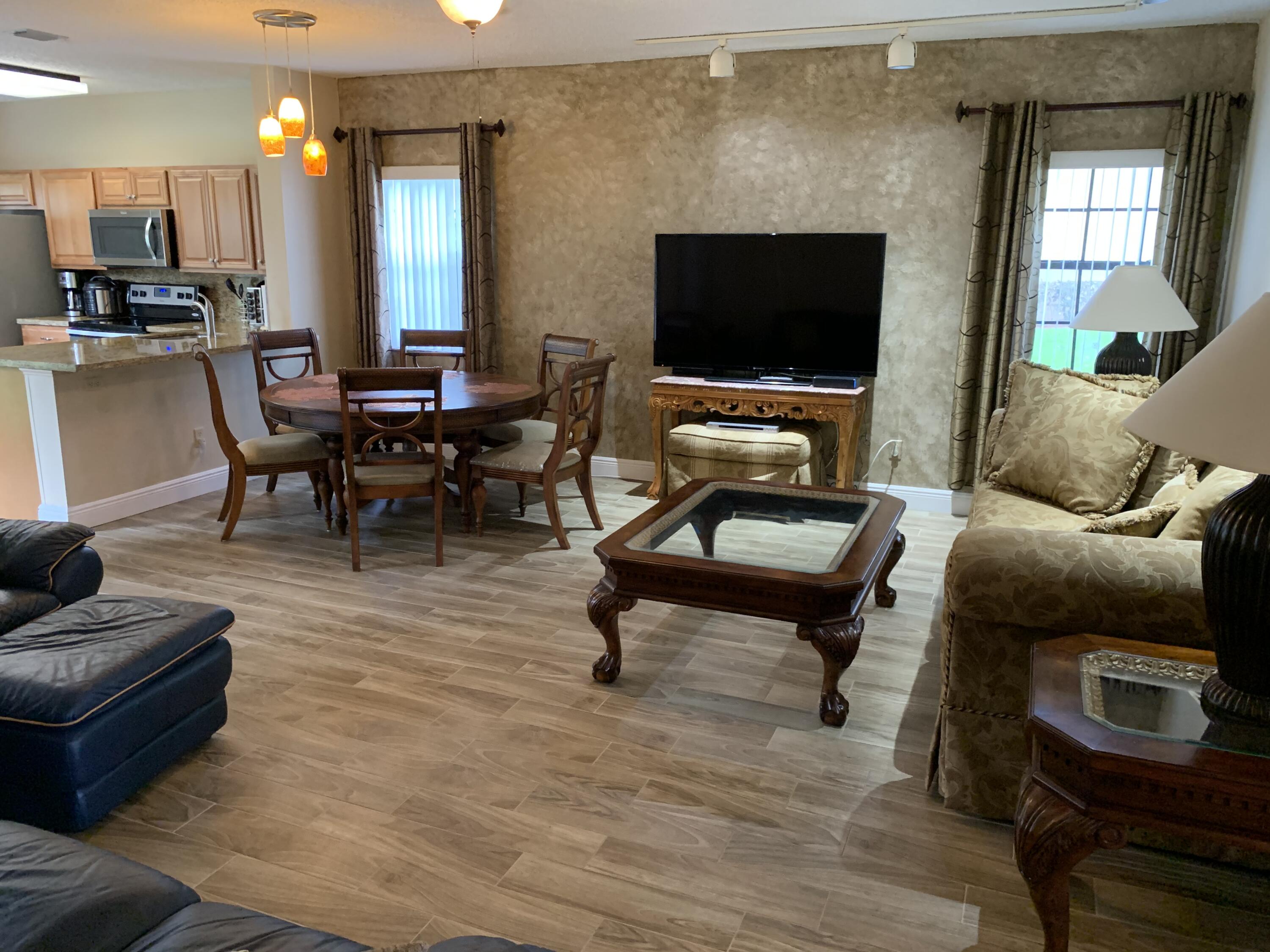 6674 Montego Bay Boulevard, Unit E Boca Raton, FL 33433 - Photo 4 of 18 a living room with furniture and a flat screen tv