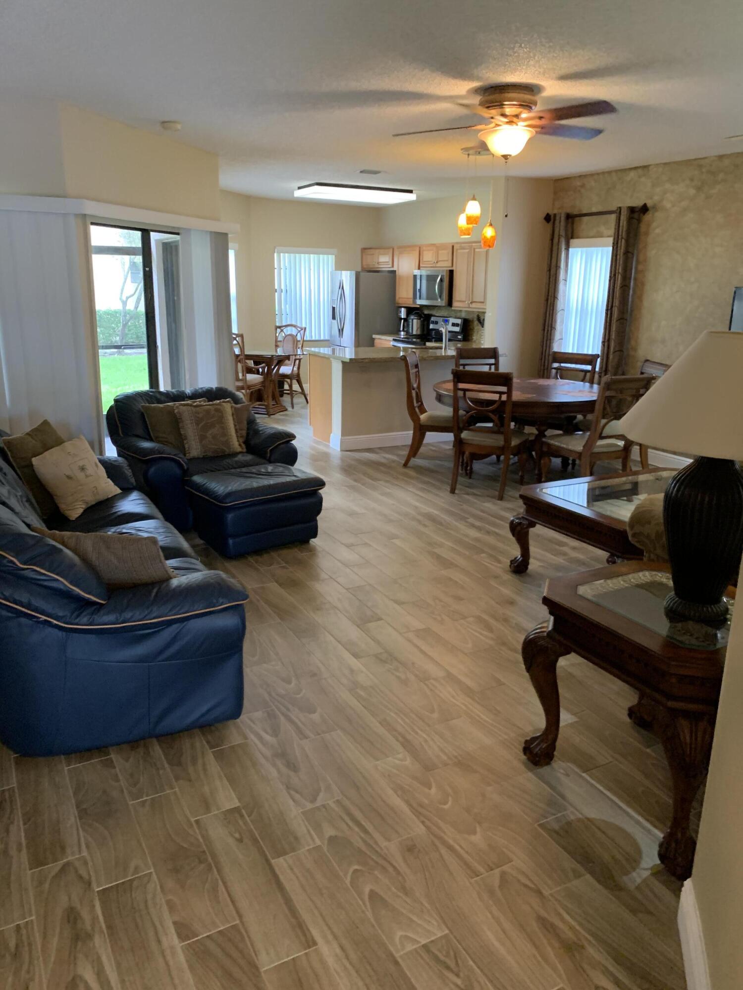 6674 Montego Bay Boulevard, Unit E Boca Raton, FL 33433 - Photo 5 of 18 a living room with furniture and a dining table