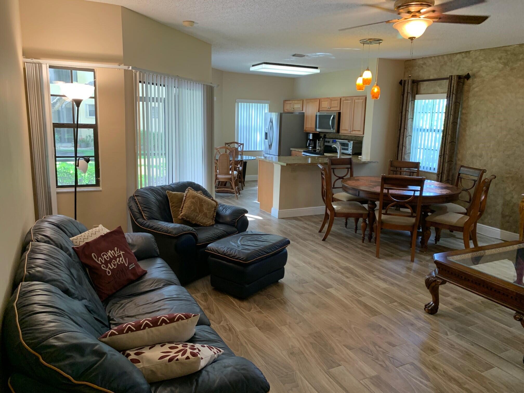 6674 Montego Bay Boulevard, Unit E Boca Raton, FL 33433 - Photo 7 of 18 a living room with furniture and a large window