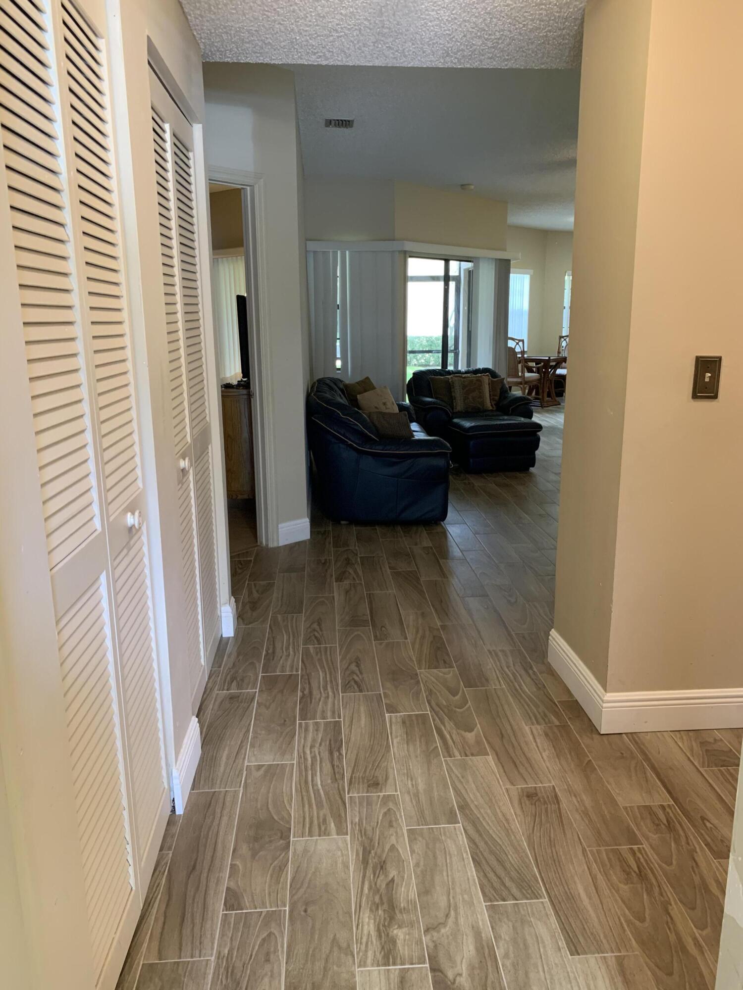 6674 Montego Bay Boulevard, Unit E Boca Raton, FL 33433 - Photo 9 of 18 a living room with furniture and a gate