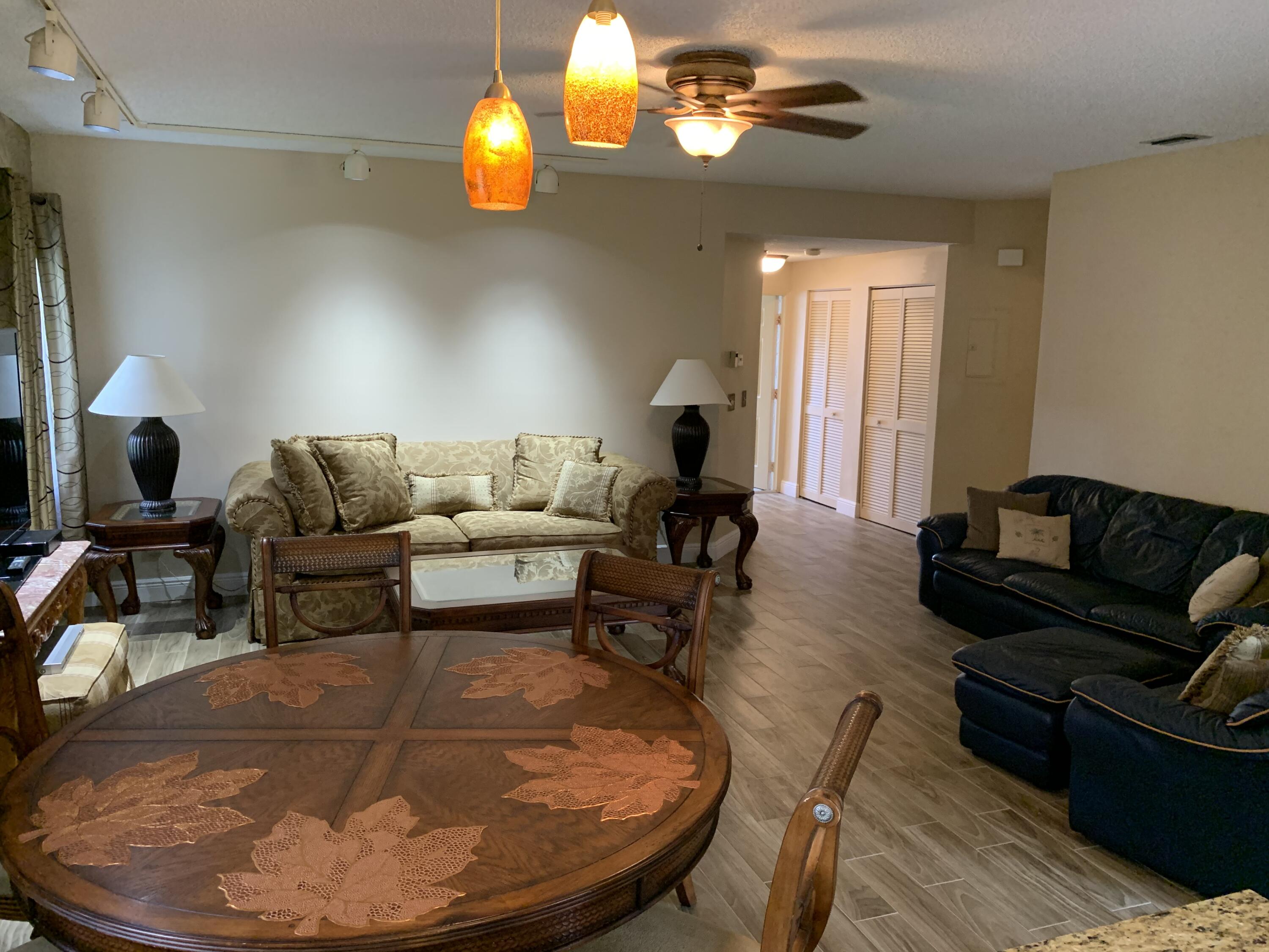 6674 Montego Bay Boulevard, Unit E Boca Raton, FL 33433 - Photo 10 of 18 a living room with furniture and wooden floor