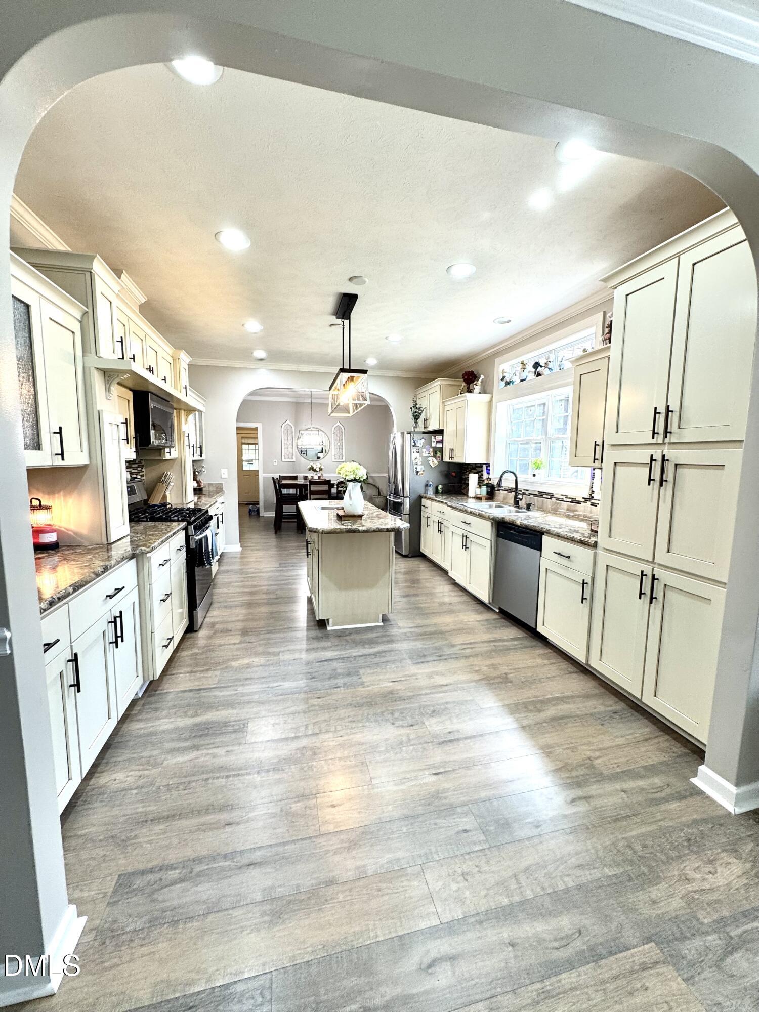 640 Tart Town Road Dunn, NC 28334 - Photo 21 of 71 a large kitchen with stainless steel appliances lots of counter space and wooden floor