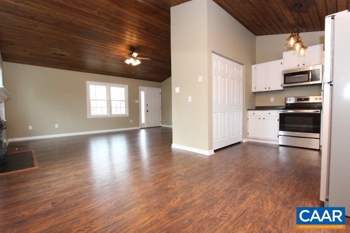60 Geranium Road Ruckersville, VA 22968 - Photo 9 of 21 a view of a kitchen with a stove wooden cabinets and wooden floor