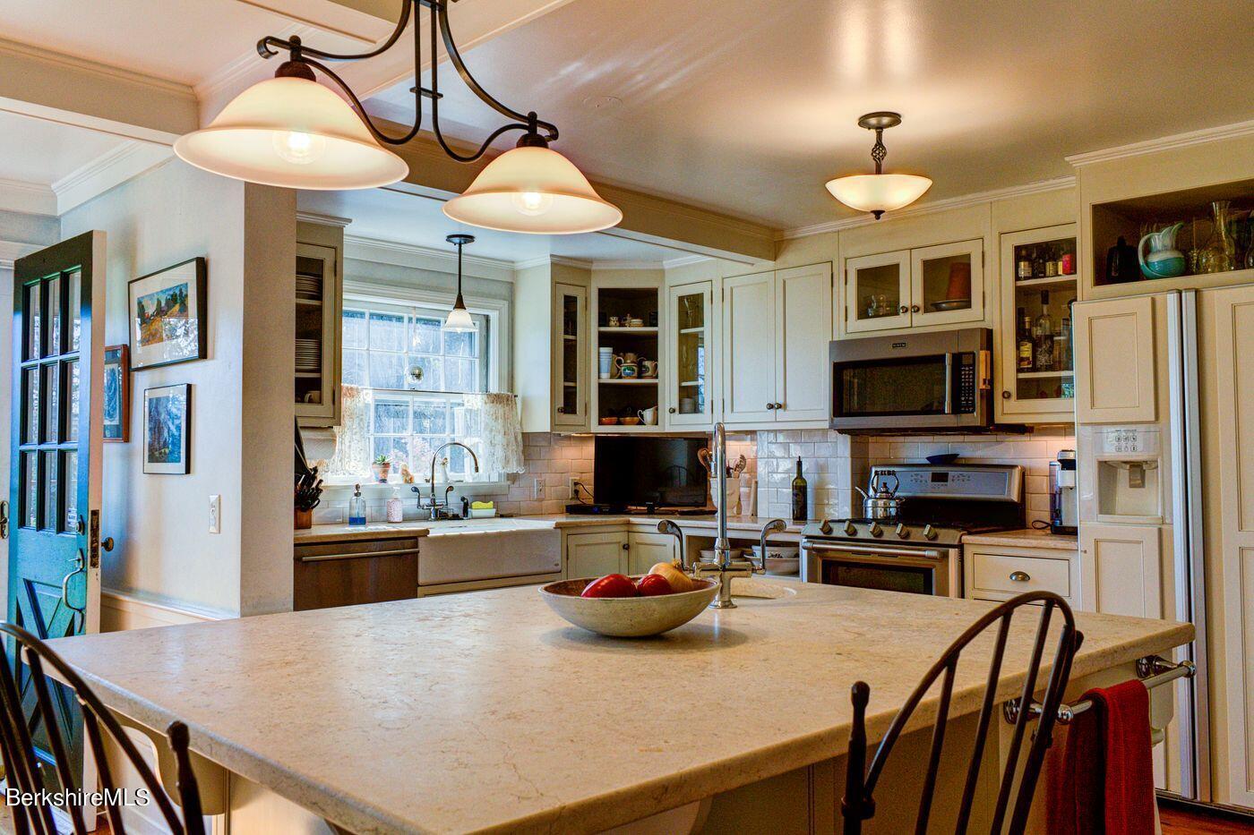 331 Rossiter Road Richmond, MA 01254 - Photo 9 of 28 a kitchen with stainless steel appliances wooden floor dining table and chairs