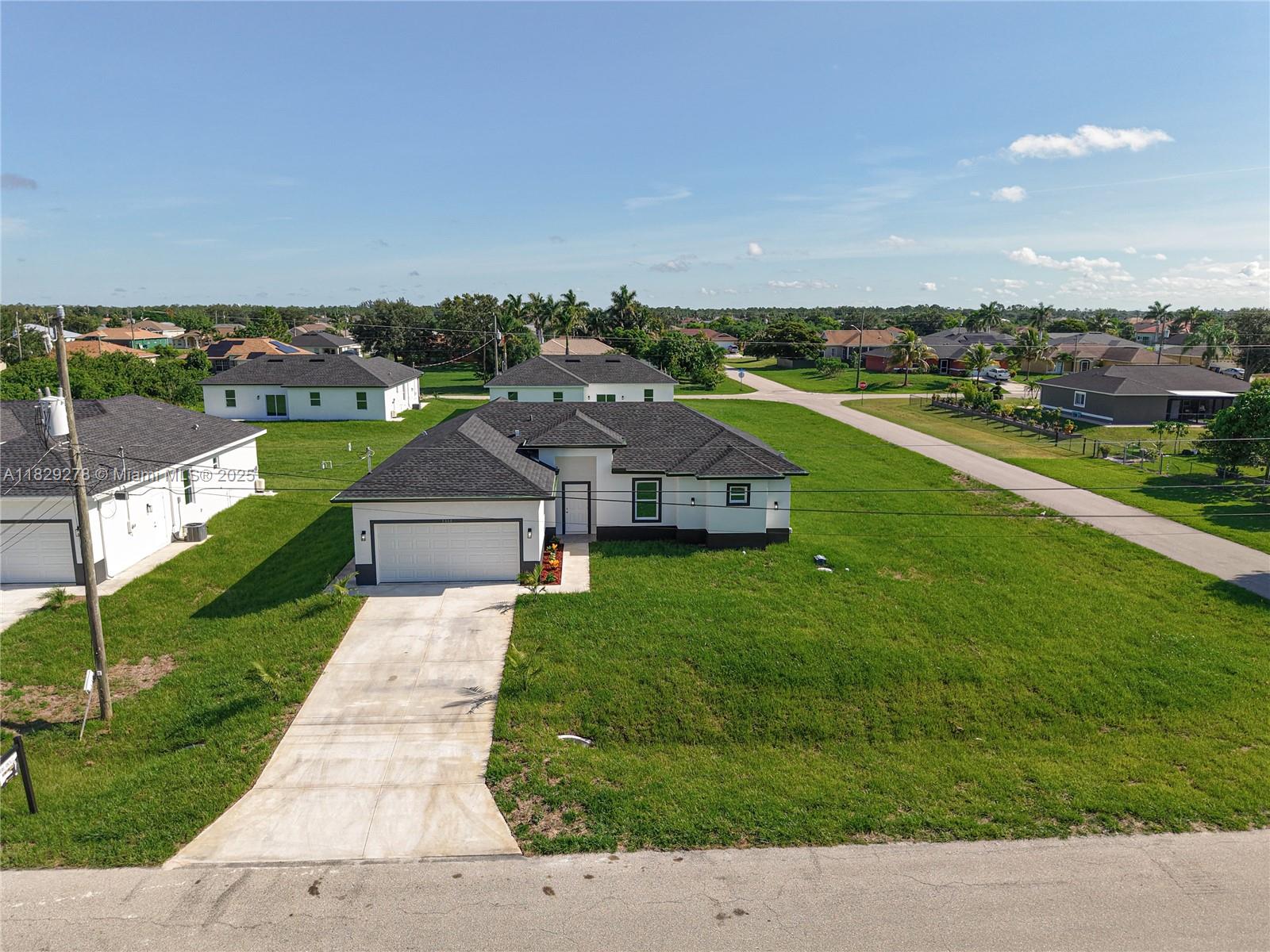 an aerial view of a house with a garden and trees