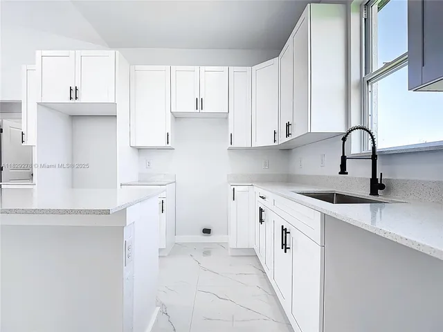 a kitchen with stainless steel appliances a refrigerator and cabinets