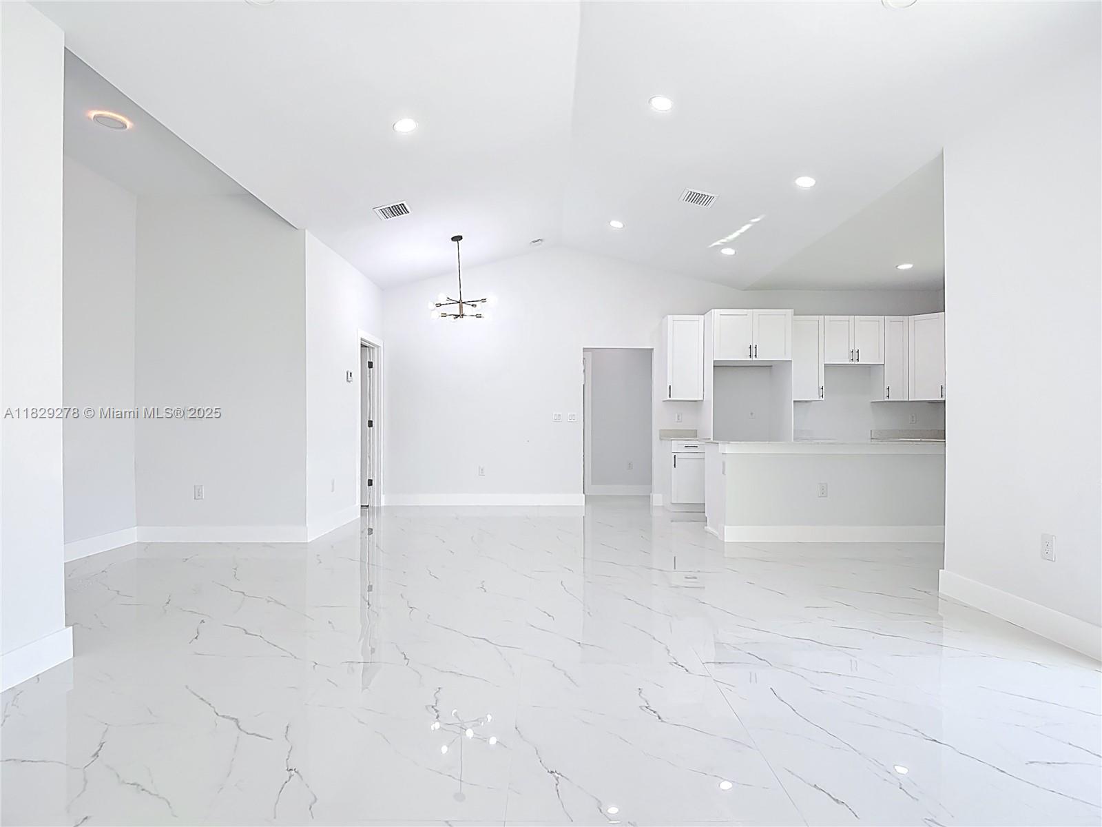5002 Bygone Street Lehigh Acres, FL 33971 - Photo 29 of 51 a view of a kitchen with refrigerator and white walls