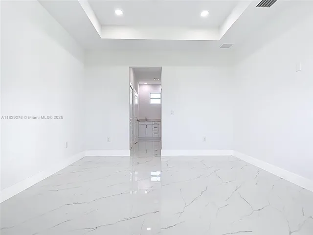 a spacious bathroom with a double vanity sink a mirror and shower