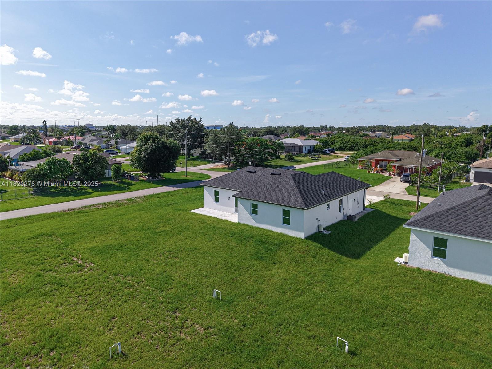 5002 Bygone Street Lehigh Acres, FL 33971 - Photo 48 of 51 a aerial view of a house with garden