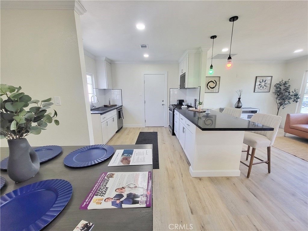 13927 Brightwell Avenue Paramount, CA 90723 - Photo 11 of 36 a living room with furniture and wooden floor
