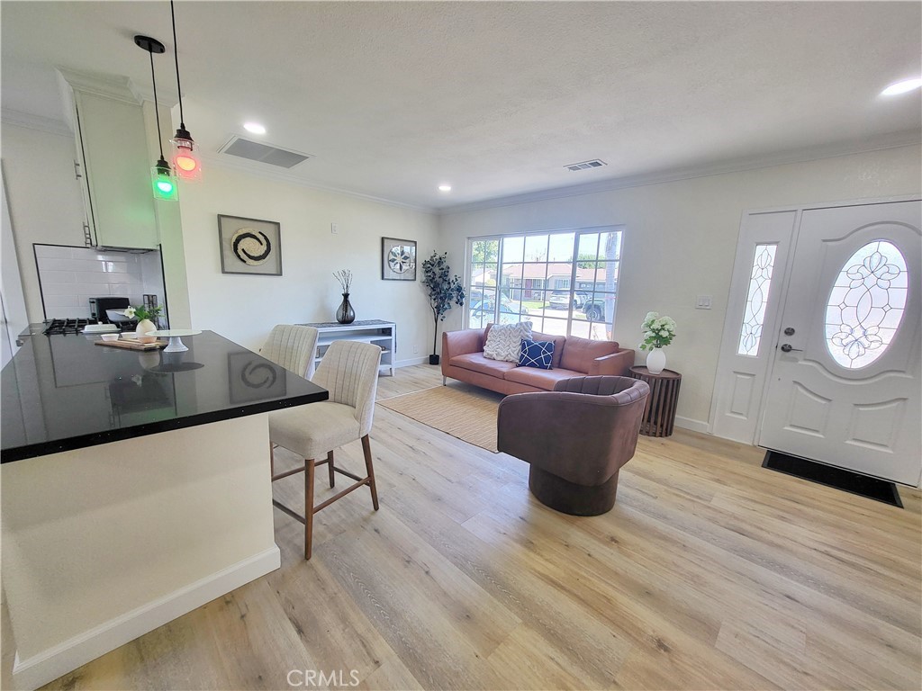 13927 Brightwell Avenue Paramount, CA 90723 - Photo 12 of 36 a living room with furniture and a wooden floor
