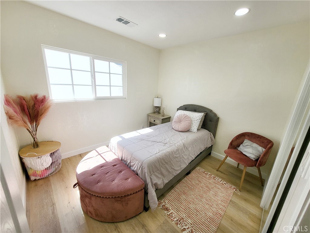 13927 Brightwell Avenue Paramount, CA 90723 - Photo 20 of 36 a bedroom with a bed and a chair