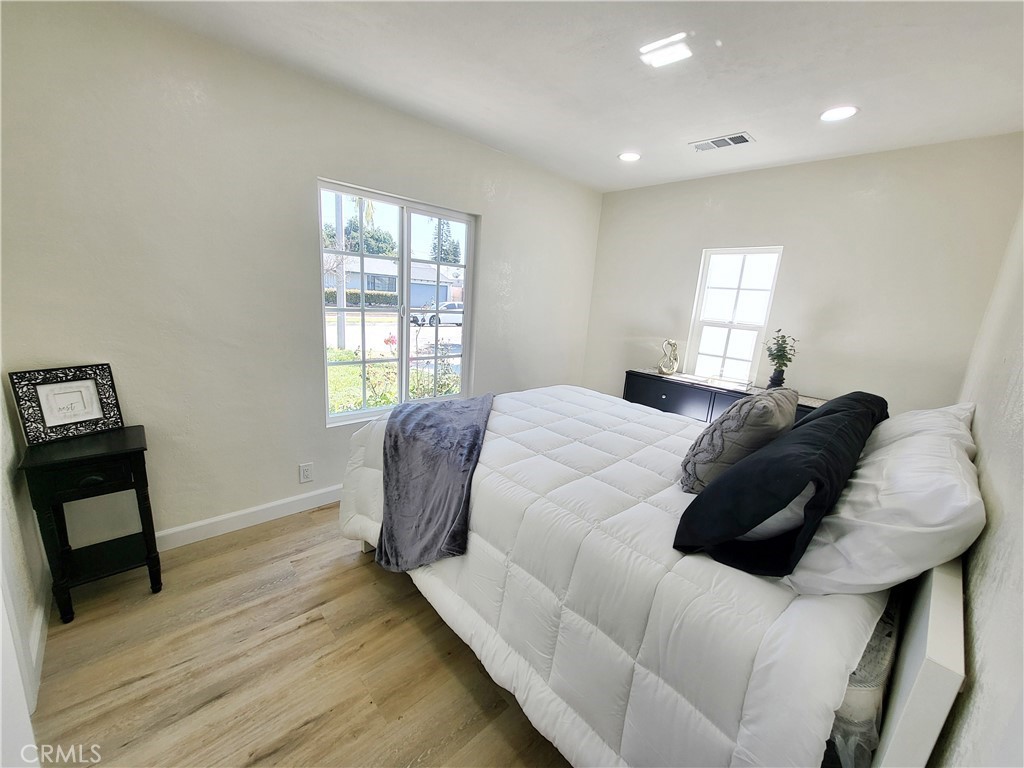13927 Brightwell Avenue Paramount, CA 90723 - Photo 22 of 36 a bedroom with a bed and a window