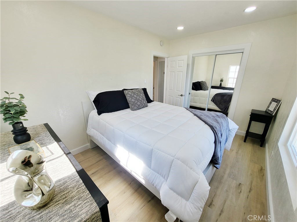 13927 Brightwell Avenue Paramount, CA 90723 - Photo 24 of 36 a bedroom with a bed and wooden floor