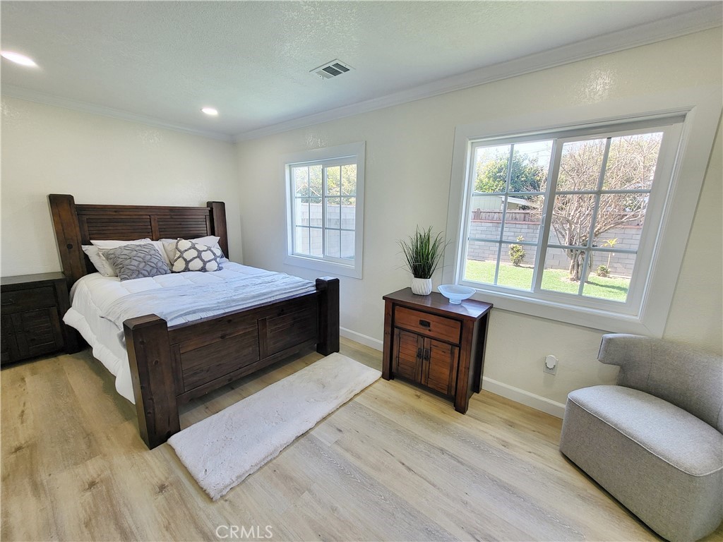 13927 Brightwell Avenue Paramount, CA 90723 - Photo 27 of 36 a bedroom with a large bed and a couch