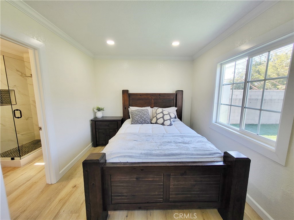 13927 Brightwell Avenue Paramount, CA 90723 - Photo 28 of 36 a bedroom with a bed and a window