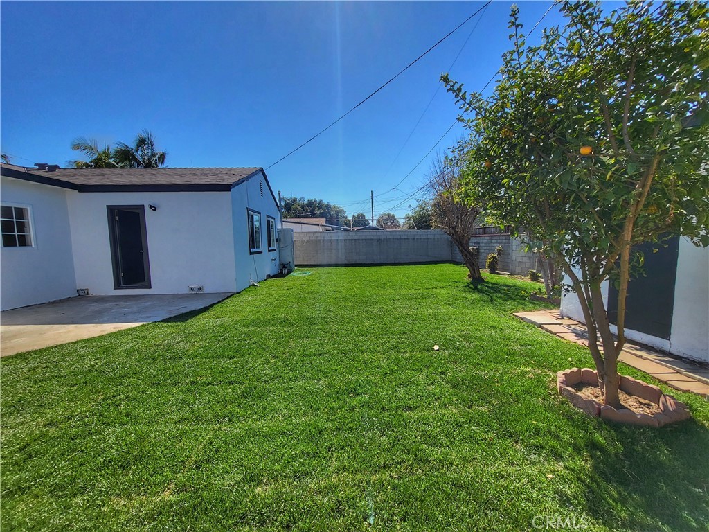 13927 Brightwell Avenue Paramount, CA 90723 - Photo 35 of 36 a view of a backyard with a garden