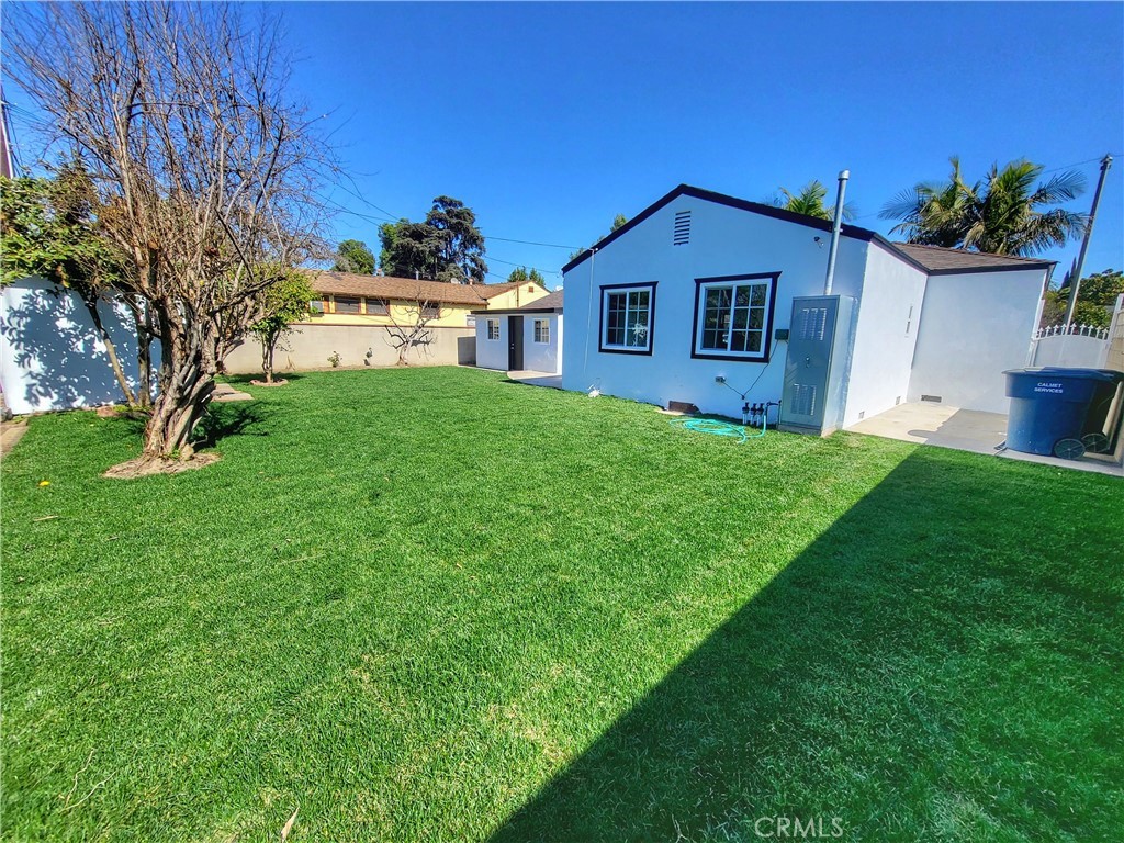 13927 Brightwell Avenue Paramount, CA 90723 - Photo 36 of 36 a front view of a house with a yard