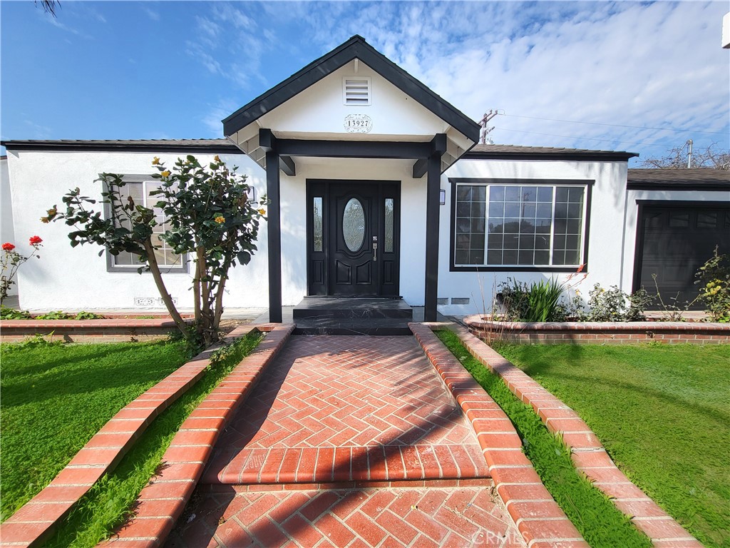 13927 Brightwell Avenue Paramount, CA 90723 - Photo 4 of 36 a front view of a house with garden