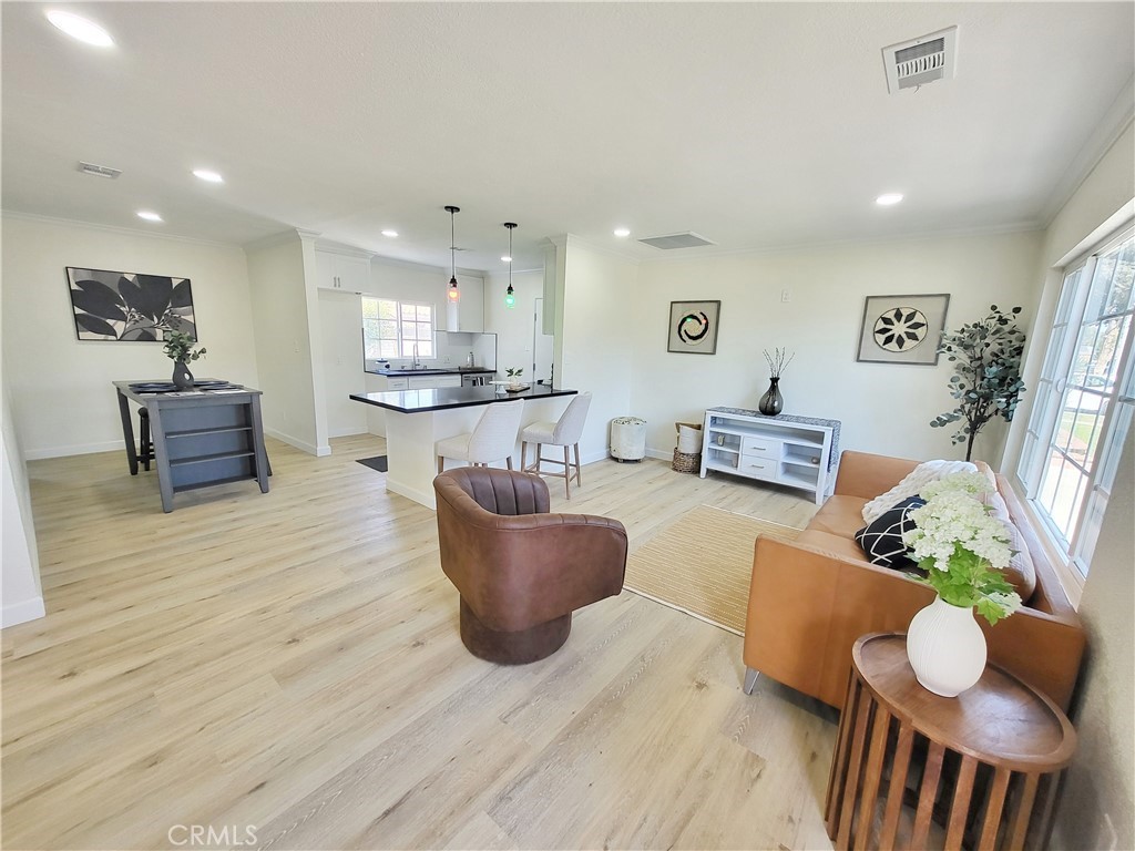 13927 Brightwell Avenue Paramount, CA 90723 - Photo 8 of 36 a living room with furniture and wooden floor