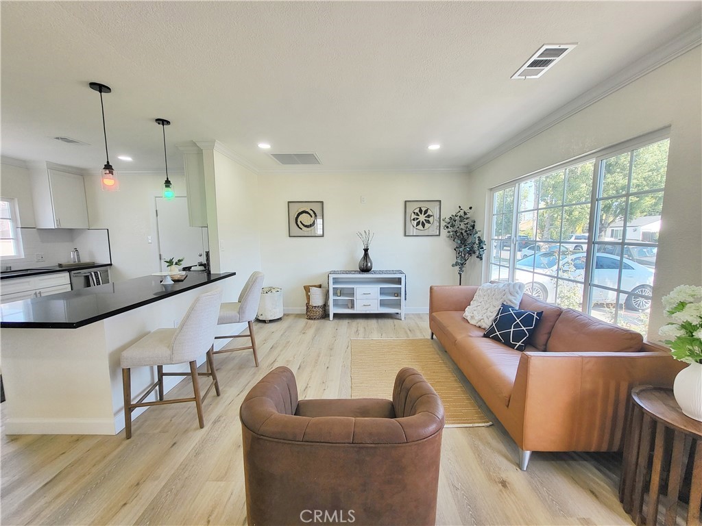 13927 Brightwell Avenue Paramount, CA 90723 - Photo 9 of 36 a living room with furniture and a large window