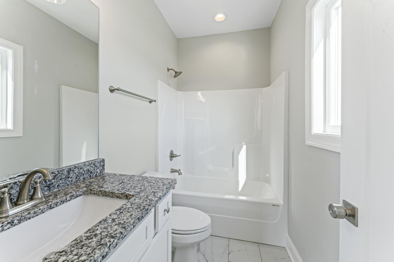 2132 Gracie Bug Loop Murfreesboro, TN 37128 - Photo 13 of 24 a bathroom with a granite countertop sink a toilet and shower