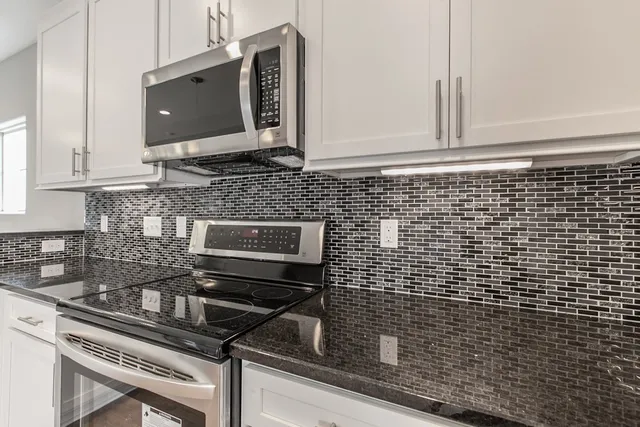 a kitchen with a stove microwave and sink