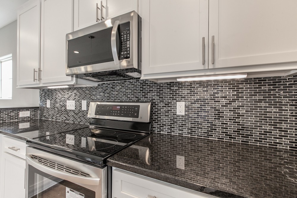 2132 Gracie Bug Loop Murfreesboro, TN 37128 - Photo 3 of 21 a kitchen with a stove microwave and sink