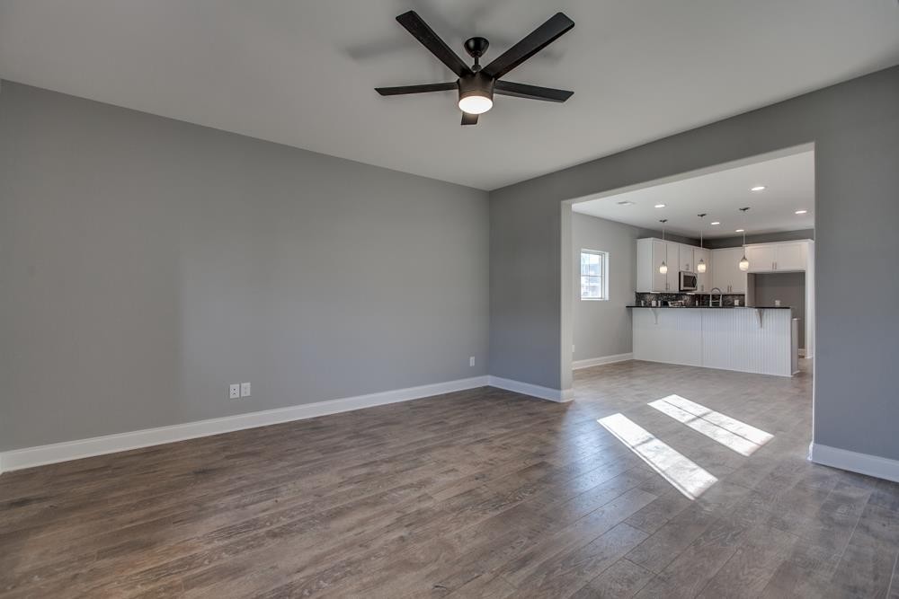 2132 Gracie Bug Loop Murfreesboro, TN 37128 - Photo 5 of 21 an empty room with wooden floor and windows