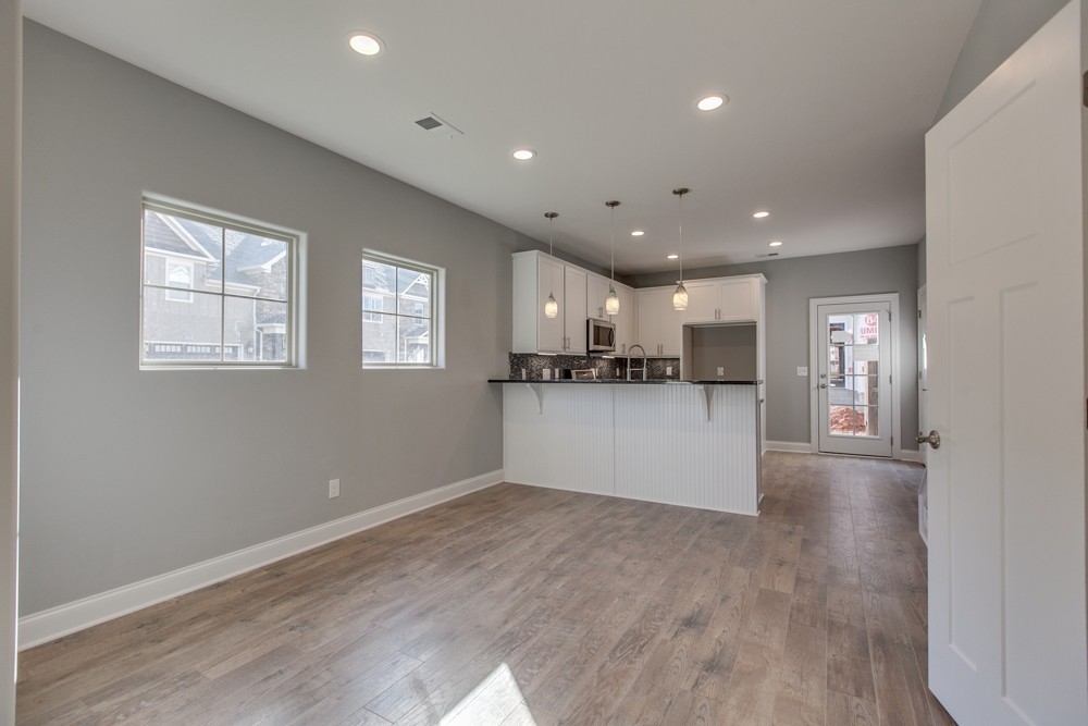 2132 Gracie Bug Loop Murfreesboro, TN 37128 - Photo 9 of 21 a view of kitchen with kitchen island white cabinets and wooden floor