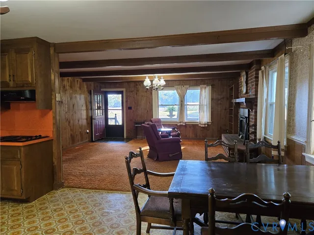 a kitchen with stainless steel appliances kitchen island granite countertop a refrigerator and a stove top oven