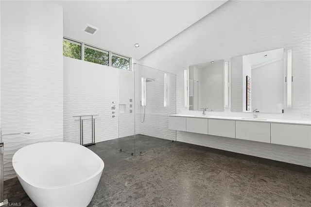 a bedroom with a bed and a couch next to a window