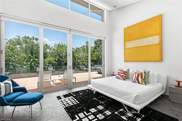 a living room with furniture kitchen view and a flat screen tv