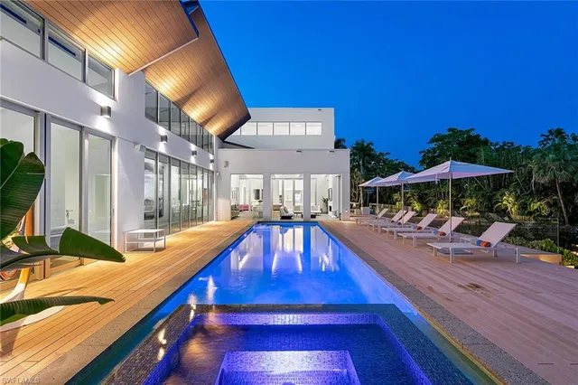 a view of a patio with a table and chairs under an umbrella