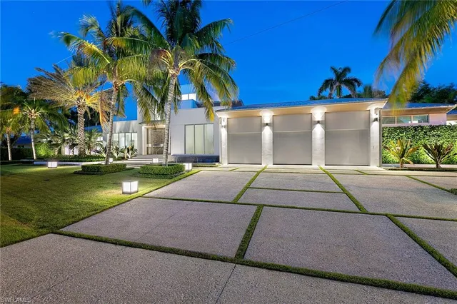 a house with a yard and palm trees