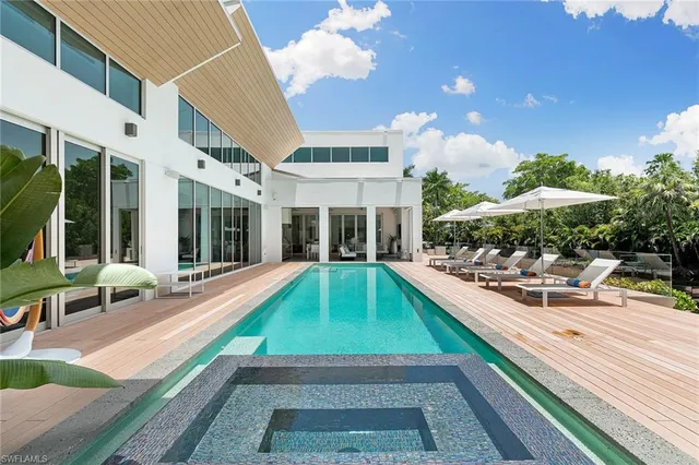 a swimming pool with outdoor seating and yard