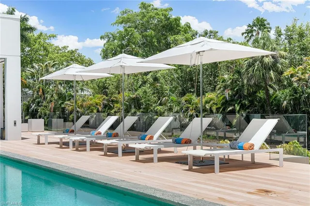 a view of a patio with table and chairs under an umbrella