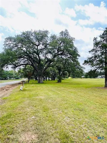 a view of a swimming pool and trees in the background