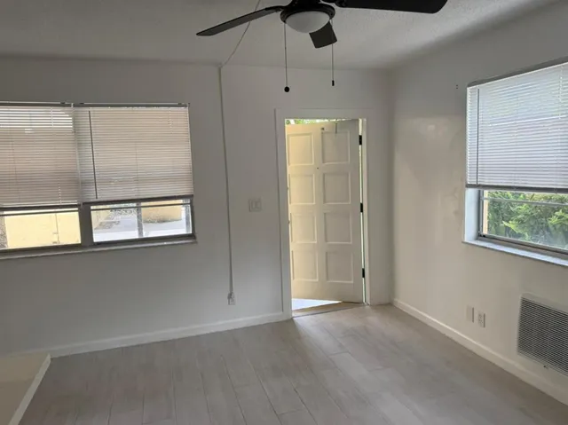 an empty room with windows and closet