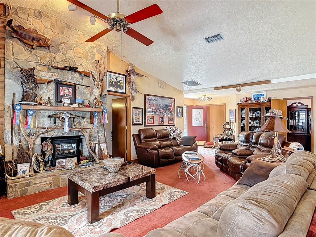 24545 Snail Road Astor, FL 32102 - Photo 11 of 61 a living room with furniture fireplace and a flat screen tv