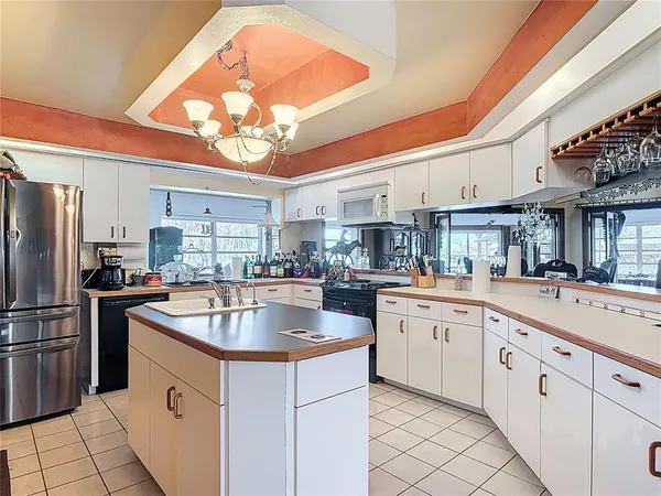 a bedroom with a bed and lamp with the floor