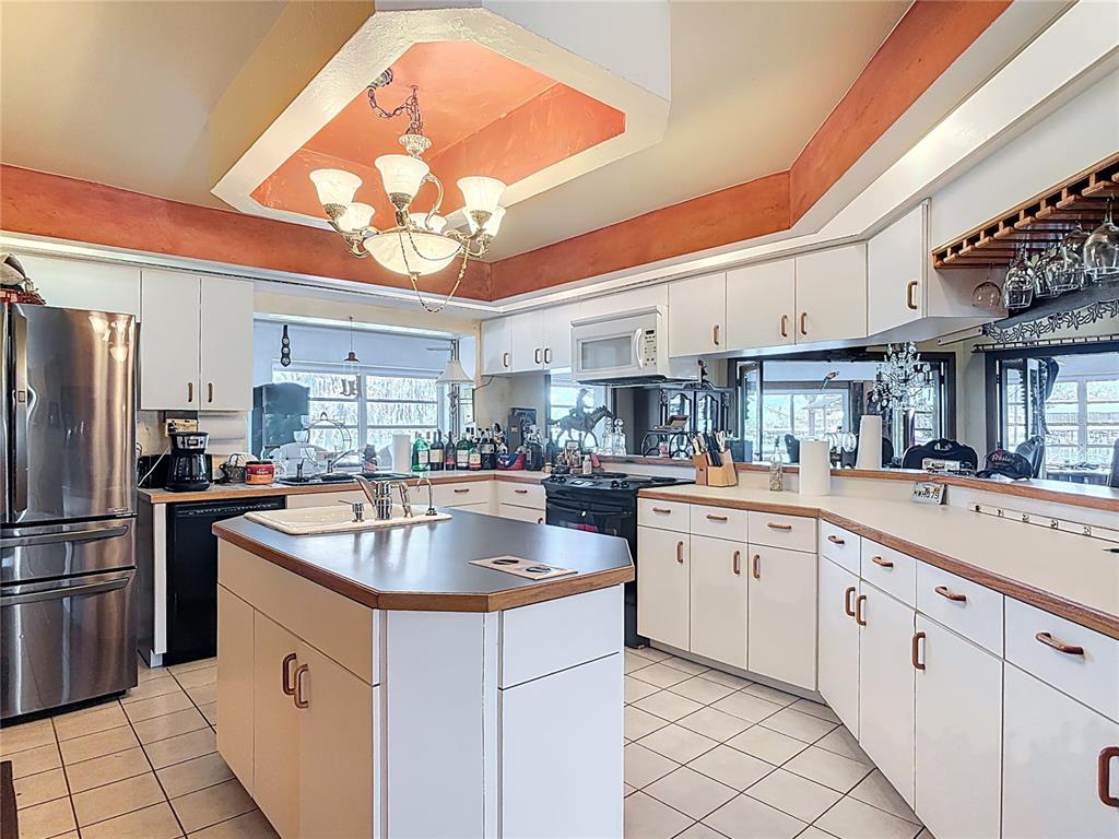 24545 Snail Road Astor, FL 32102 - Photo 13 of 61 a kitchen with cabinets a sink and stainless steel appliances